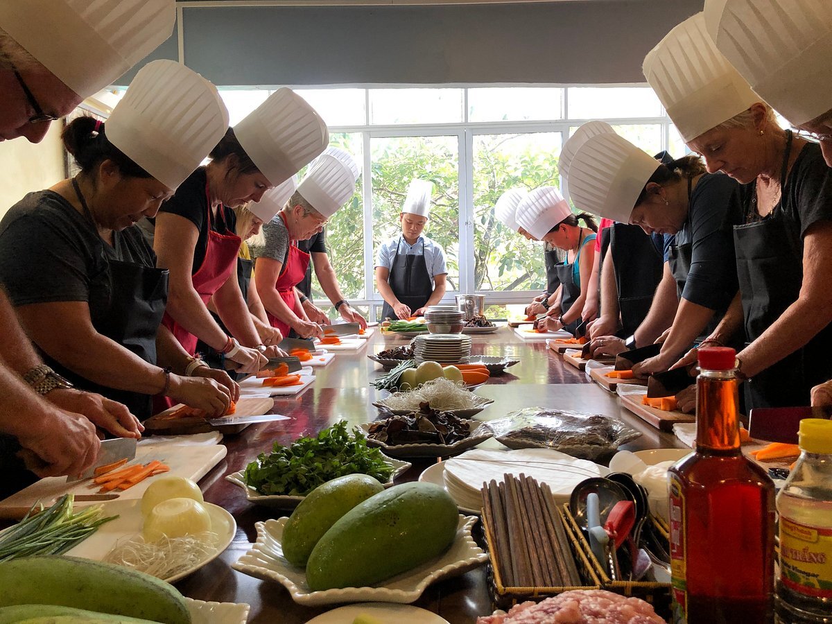 Diligent students meticulously prepare and cook traditional Vietnamese dishes.